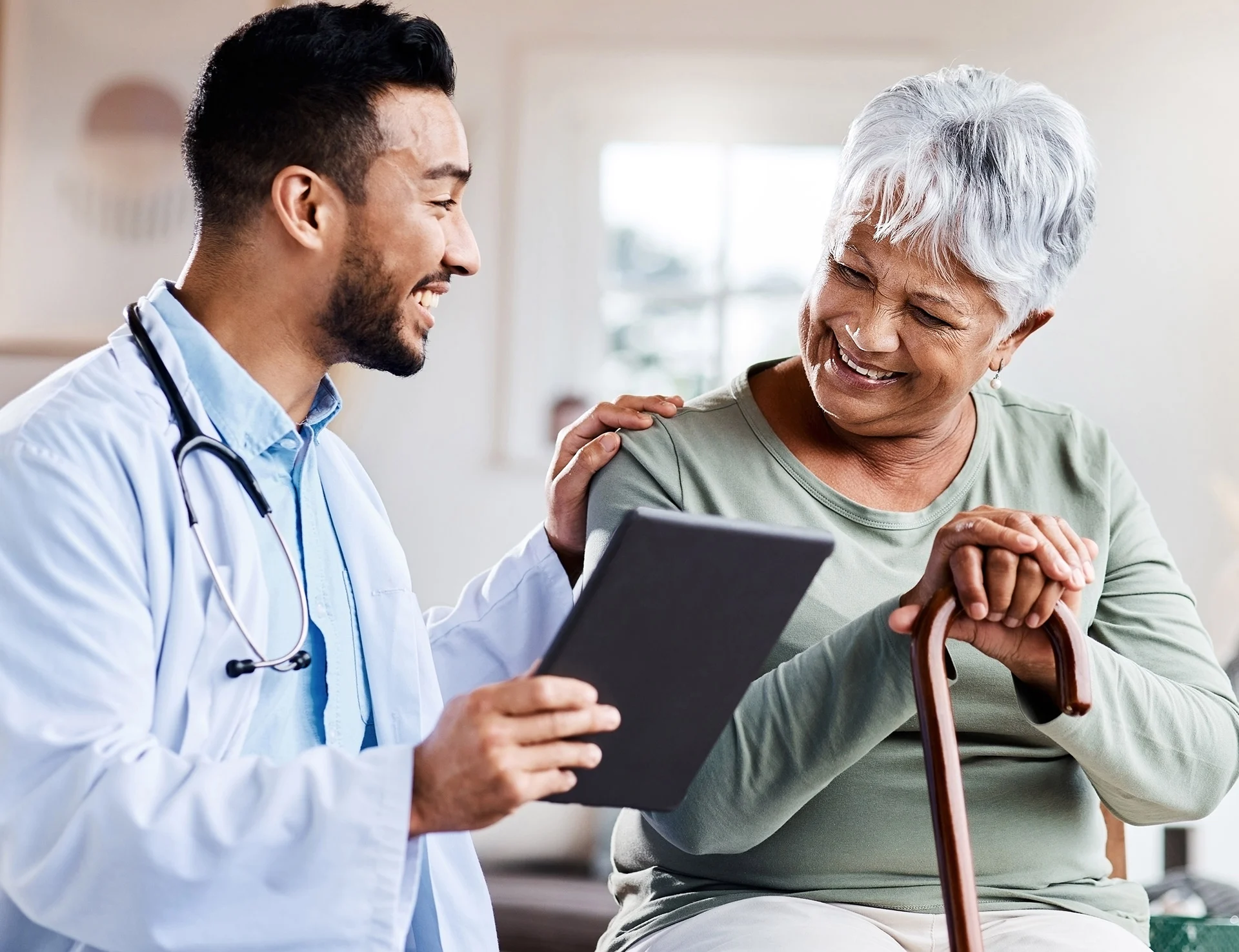 Shot of a young doctor sharing information from his digital tablet with an older patient